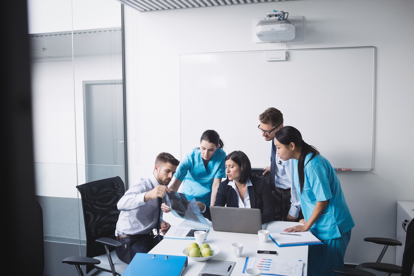 medical-team-examining-x-ray-report_107420-84799